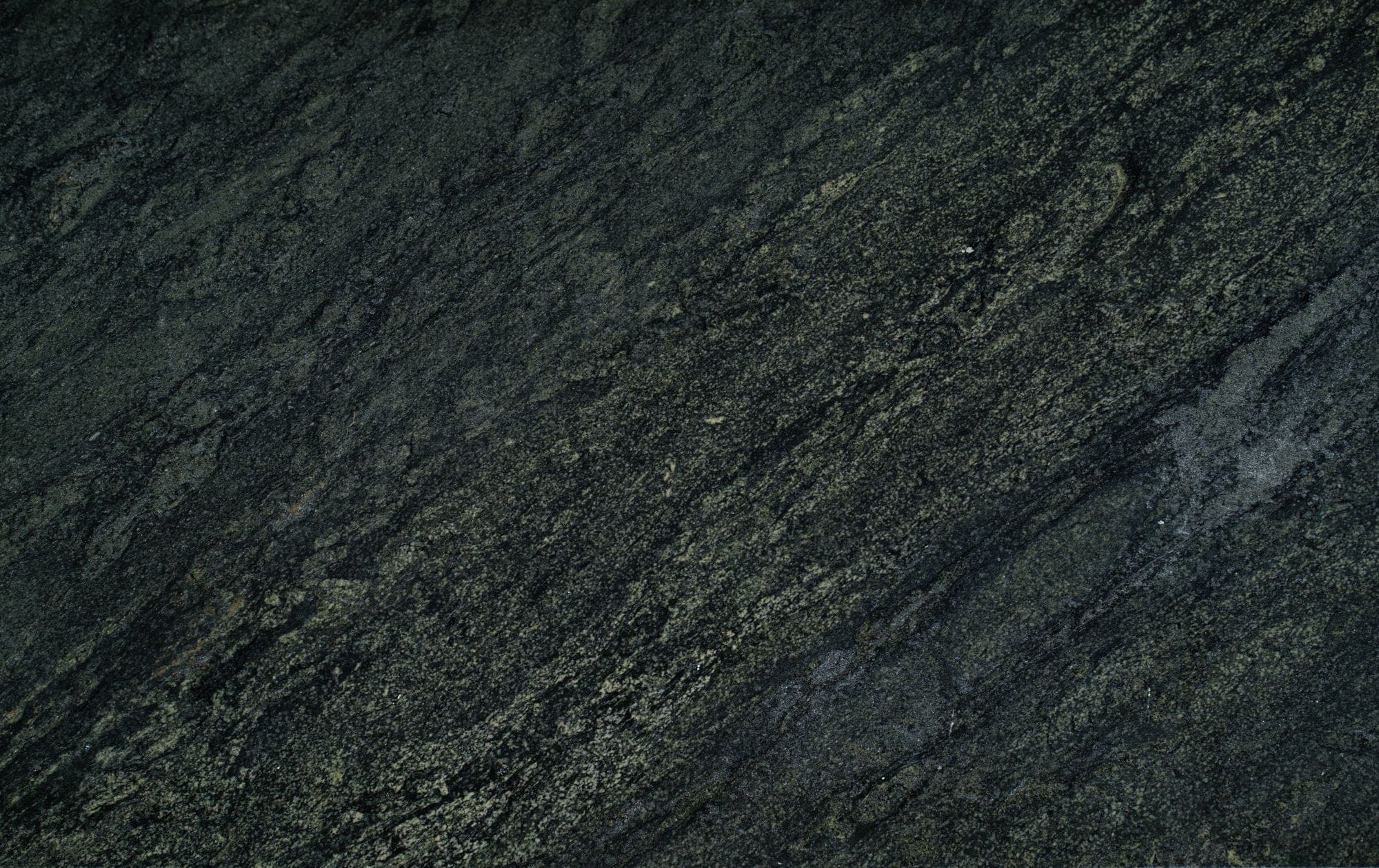 Close view of a dark granite surface showing directional figure