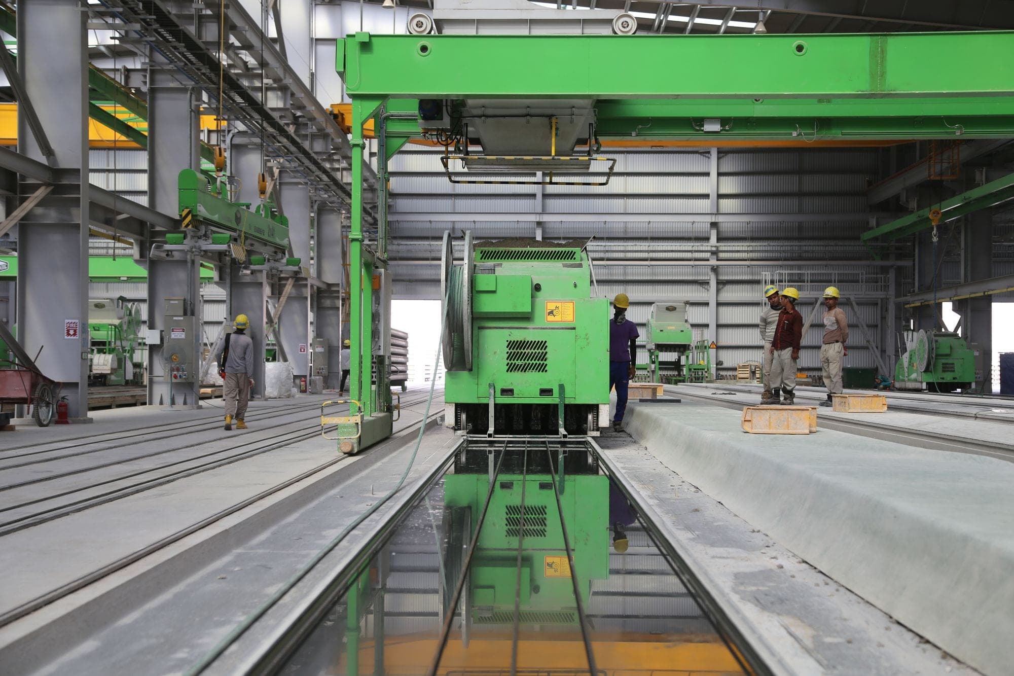 A block-cutting line in a stone factory, slabs emerging over a water channel